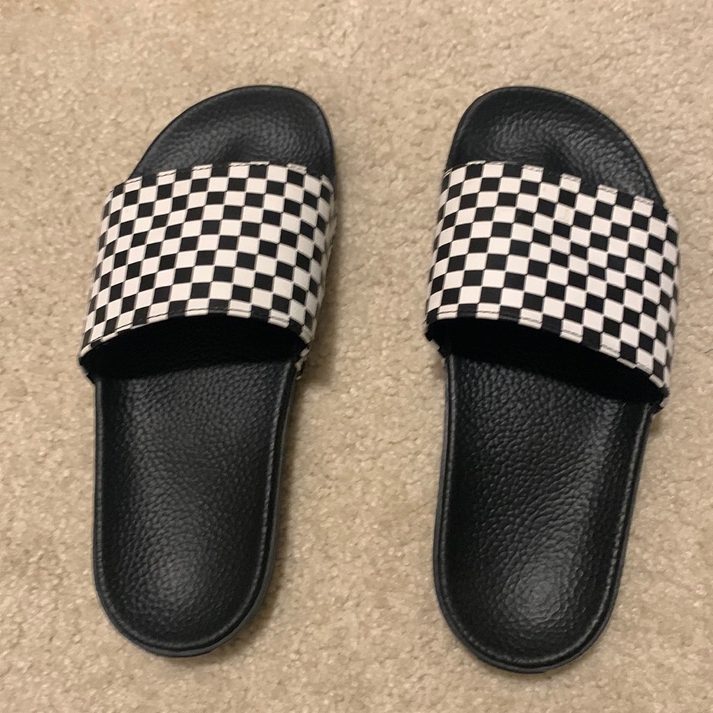 Checkered Vans slides.